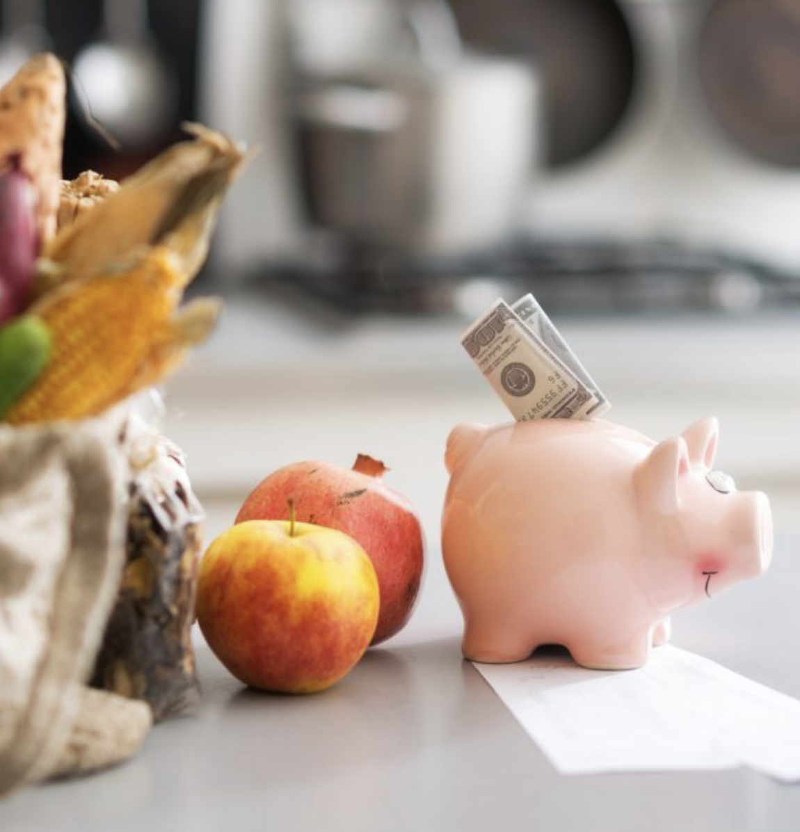 piggy bank next to apples