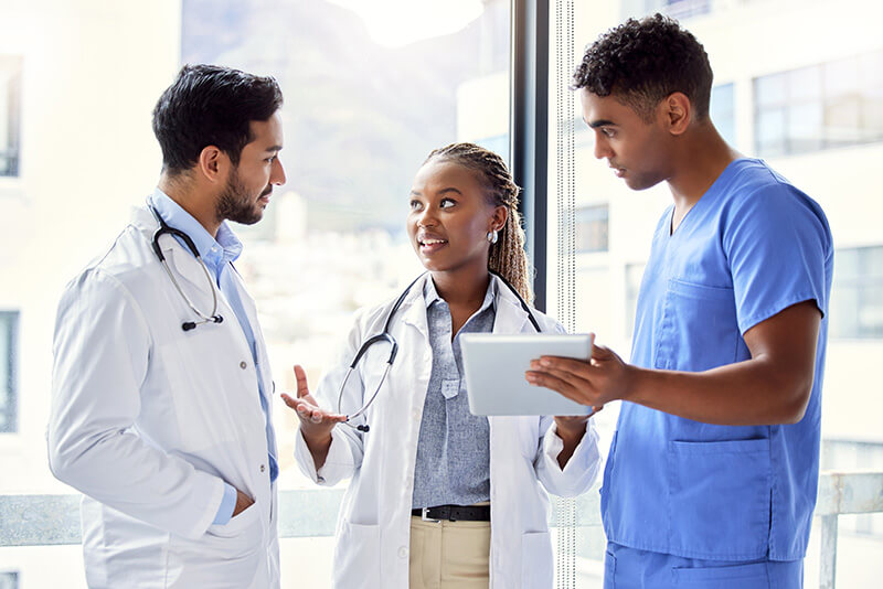 Two doctors and a nurse speaking.